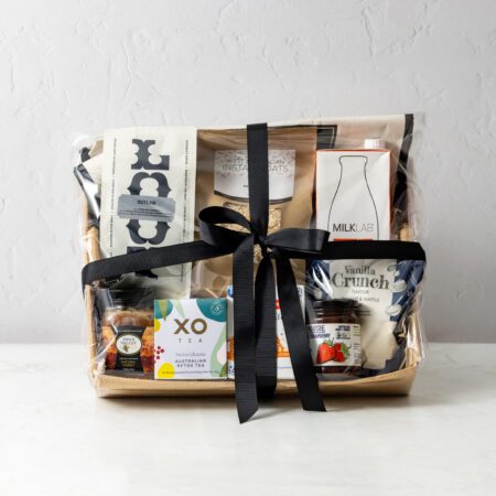Gourmet breakfast hamper featuring oats, jam, waffles, tea, coffee, pancake mix, honey and long-life milk.